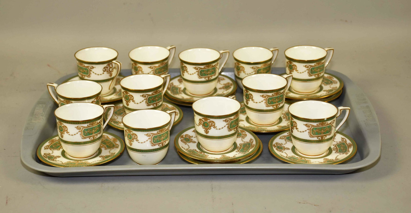 ROYAL WORCESTER SERVICE FOR TWELVE (24 PC.) CHINA: ROYAL WORCESTER SERVICE FOR TWELVE (24 PC.) CHINA CAPPUCINO CUP AND SAUCER SET. In white w/gold gilt and green decoration, C2105. Red crown stamp, 2''H x 4'' diameter. Condition: one cracked saucer. E