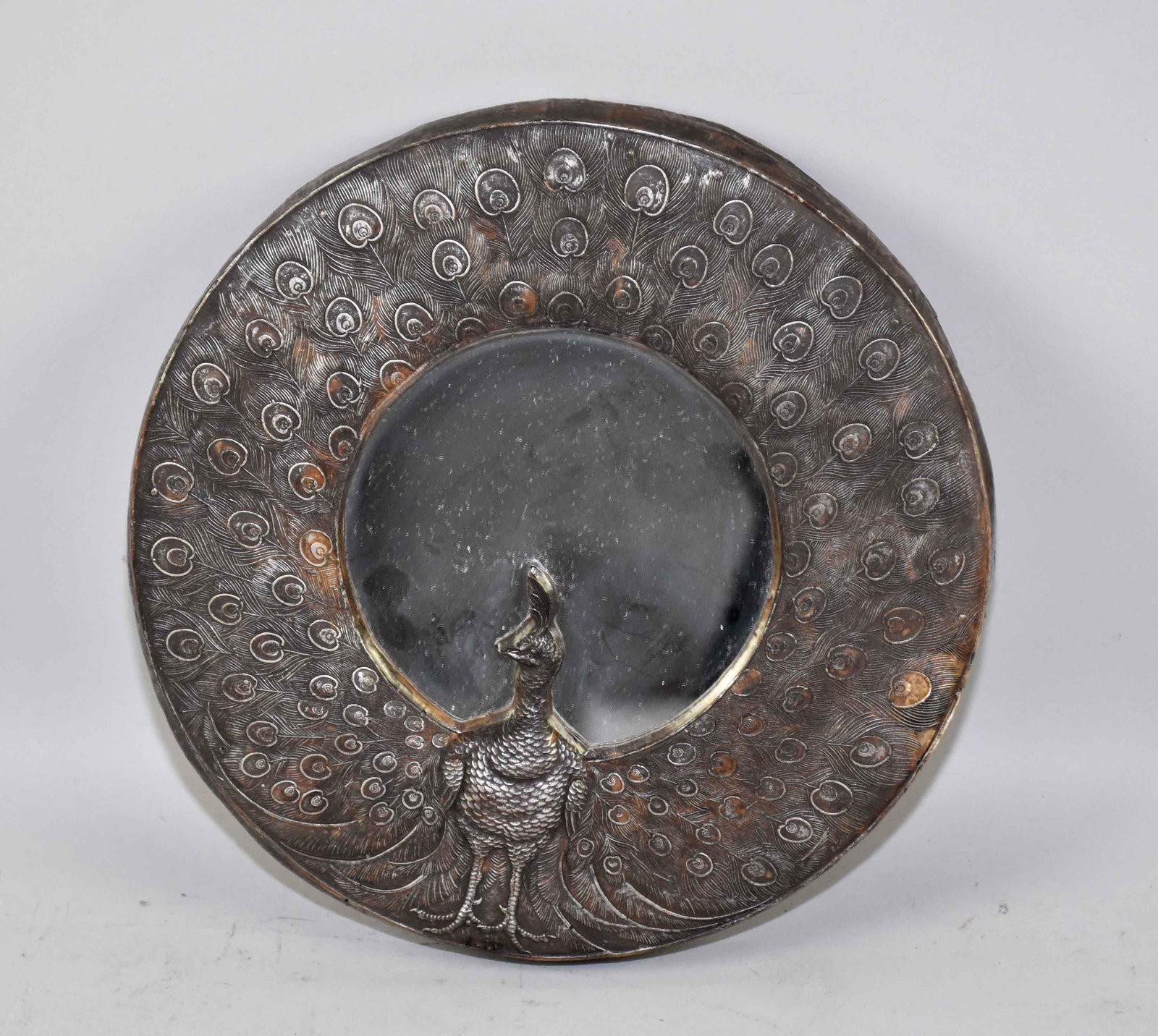 OVAL PEACOCK MIRROR. 9.5'' diameter. Estate of Stephen: OVAL PEACOCK MIRROR. 9.5'' diameter. Estate of Stephen Totter.