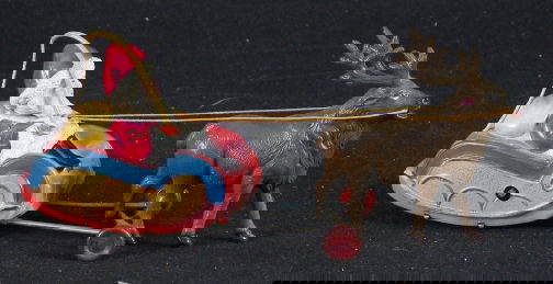 CELLULOID SANTA SLEIGH W. RAIN: CELLULOID SANTA SLEIGH TOY. Vintage Christmas celluloid toy, Santa in sleigh with whip and raindeer, movable wheels, metal base. Marked: impressed: Made in Japan. Original paper label: SED TCTMA INSPE