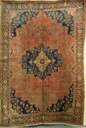 PERSIAN SAROUK FARAHAN.: ANTIQUE PERSIAN SAROUK FARAHAN. Main colors are navy blue, light red, and vegetal forms in light green. Size: 11'3'' x 8'9'' Condition: some sewn repairs along the longitude in the center, rewoven are