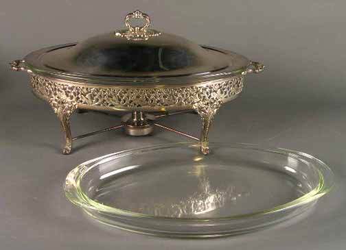 REED & BARTON CHAFING DISH: REED & BARTON CHAFING DISH. Reed and Barton silverplated oval footed chafing dish with heating element and two pyrex glass inserts, acanthus decorated legs with wide oval reticulated floral and leaf b