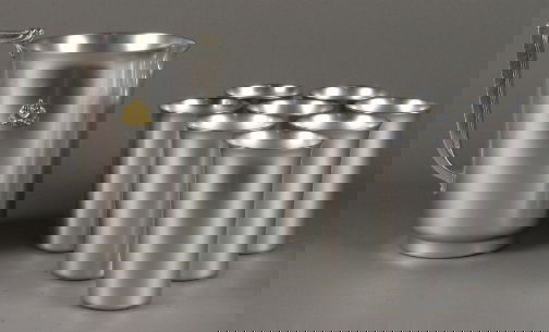 MAYFAIR PITCHER & EIGHT GLASSE: MAYFAIR PITCHER & EIGHT GLASSES. Art Deco aluminum and brass Kensington Ware Mayfair Pitcher cat. no. 7231, designed by Lurelle Guild 1934-1935. Late mark: stag head, shield and script mark. Includes