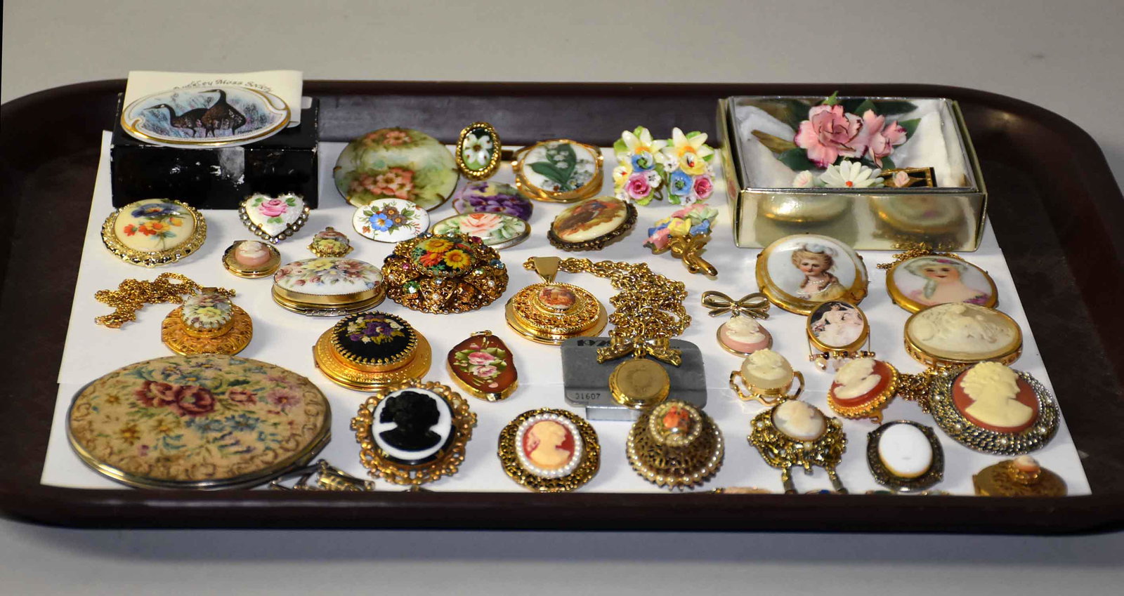 OVER (35) ASST. PCS. OF 1920s ERA COSTUME JEWELRY. With: OVER (35) ASST. PCS. OF 1920s ERA COSTUME JEWELRY. With cameos, lockets and porcelain plaque brooches and earrings. Including a M. Haskell necklace.