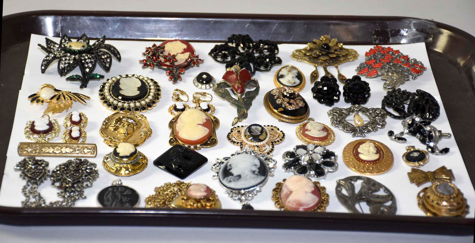 (30) MISC. PIECES OF VINTAGE JEWELRY. Victorian cameo: (30) MISC. PIECES OF VINTAGE JEWELRY. Victorian cameo jewelry. In black and red rhinestone, enamel and other mixed metal and materials. With brooches, lockets, necklaces and earrings.