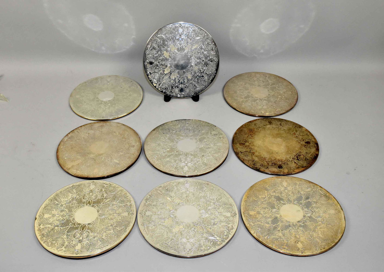(10) VINTAGE SILVERPLATED ROUND TRIVETS 'S WITH FELT: (10) VINTAGE SILVERPLATED ROUND TRIVETS 'S WITH FELT BACKS. 8 3/4 inch diameter. Sold at Harrods.