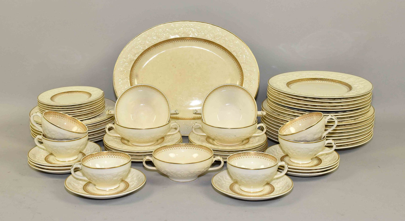 50+ SET OF GEORGE JONES & SONS ''RHAPSODY'' PATTERN: 50+ SET OF GEORGE JONES & SONS ''RHAPSODY'' PATTERN CHINA. Ivory color with gold gilt. Condition: some crazing to surface.