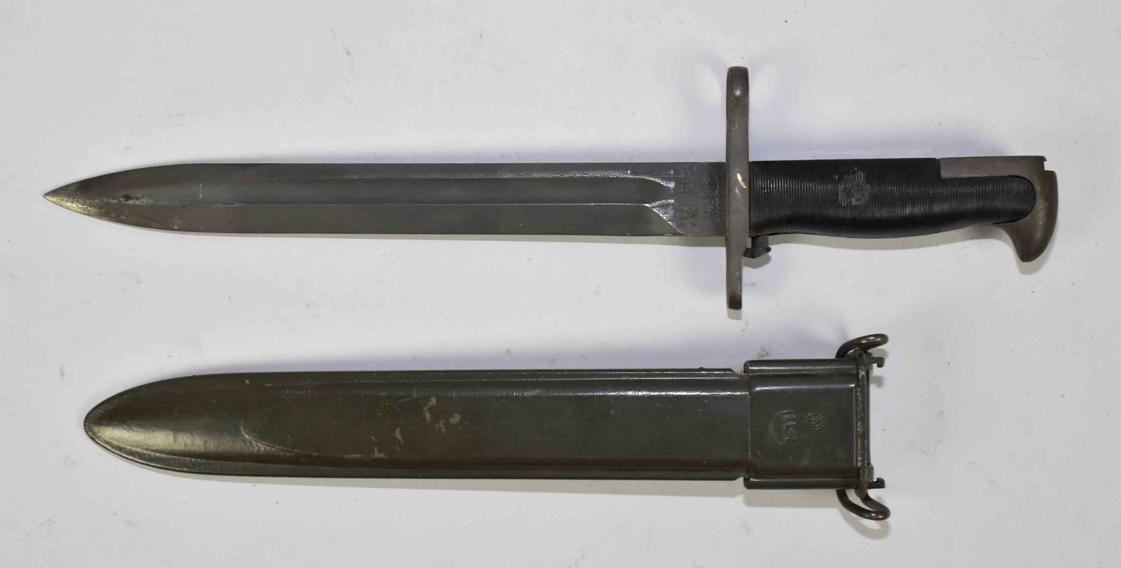 U.S. WWII M-1 RIFLE BAYONET - Shortened blade to: U.S. WWII M-1 RIFLE BAYONET - Shortened blade to 9.75''. Marked: UFH 1943. Black plastic grips, fiber sheath.