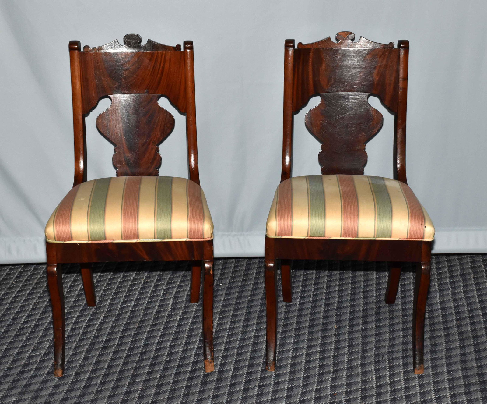 PAIR VICTORIAN ROCOCO CARVED WALNUT SIDE CHAIRS; mid: PAIR VICTORIAN ROCOCO CARVED WALNUT SIDE CHAIRS; mid 19th C; corset-shaped backs with carved crest rail and back splat; upholstered seats; cabriole legs. 33.25''H x 17.5''W x 19'' deep. One back splat