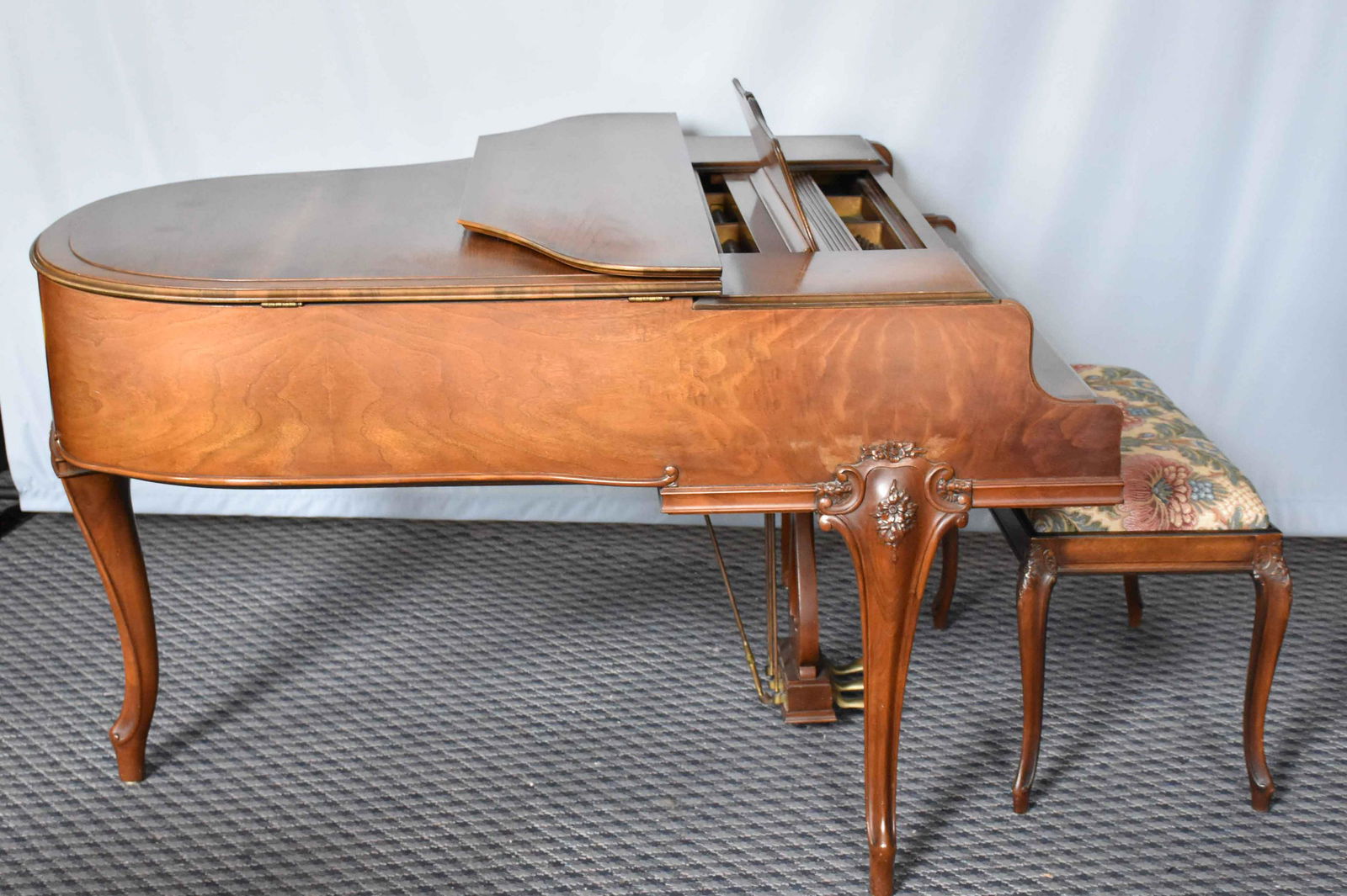 CHICKERING & SONS BABY GRAND PIANO. Carved walnut case: CHICKERING & SONS BABY GRAND PIANO. Carved walnut case with cabriole legs; circa 1940's. Serial No. 178686. With upholstered needlepoint bench. 38'' H x 52.5'' W x 61'' Deep.