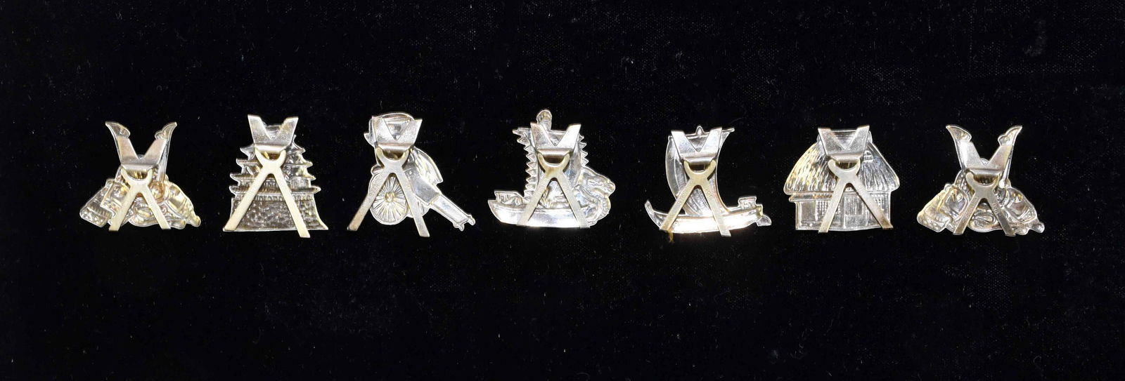 SEVEN JAPANESE SILVER FIGURAL PLACE CARD HOLDERS. 1 1/2: SEVEN JAPANESE SILVER FIGURAL PLACE CARD HOLDERS. 1 1/2 inches high each. Marked Sterling 950. Total weight 0.70 ozt. Provenance: Heinz Estate.