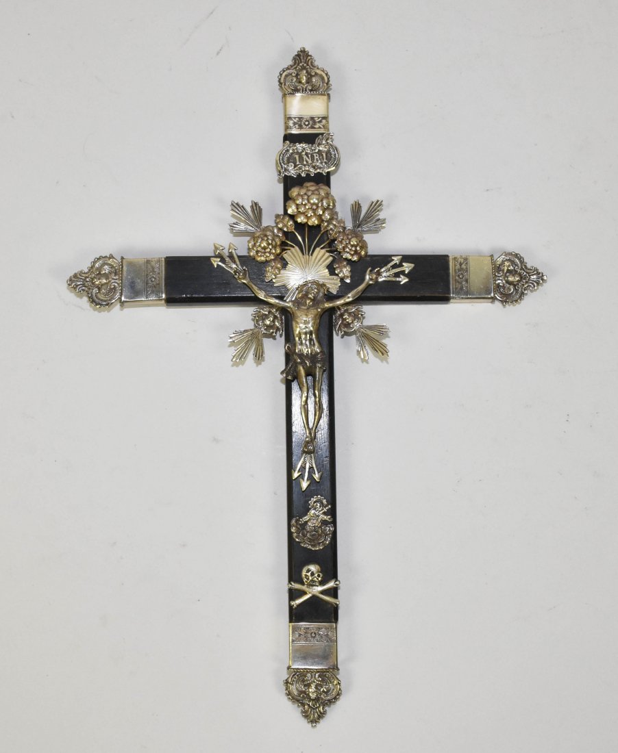 ANTIQUE EBONISED WOOD AND SILVER CRUCIFIX: ANTIQUE EBONISED WOOD AND SILVER CRUCIFIX. Beautiful ornate wood and silver crucifix. Below Christ is the skull and crossbones of Golgotha. No visible hallmarks. 18 " high; 12.5 " wide.