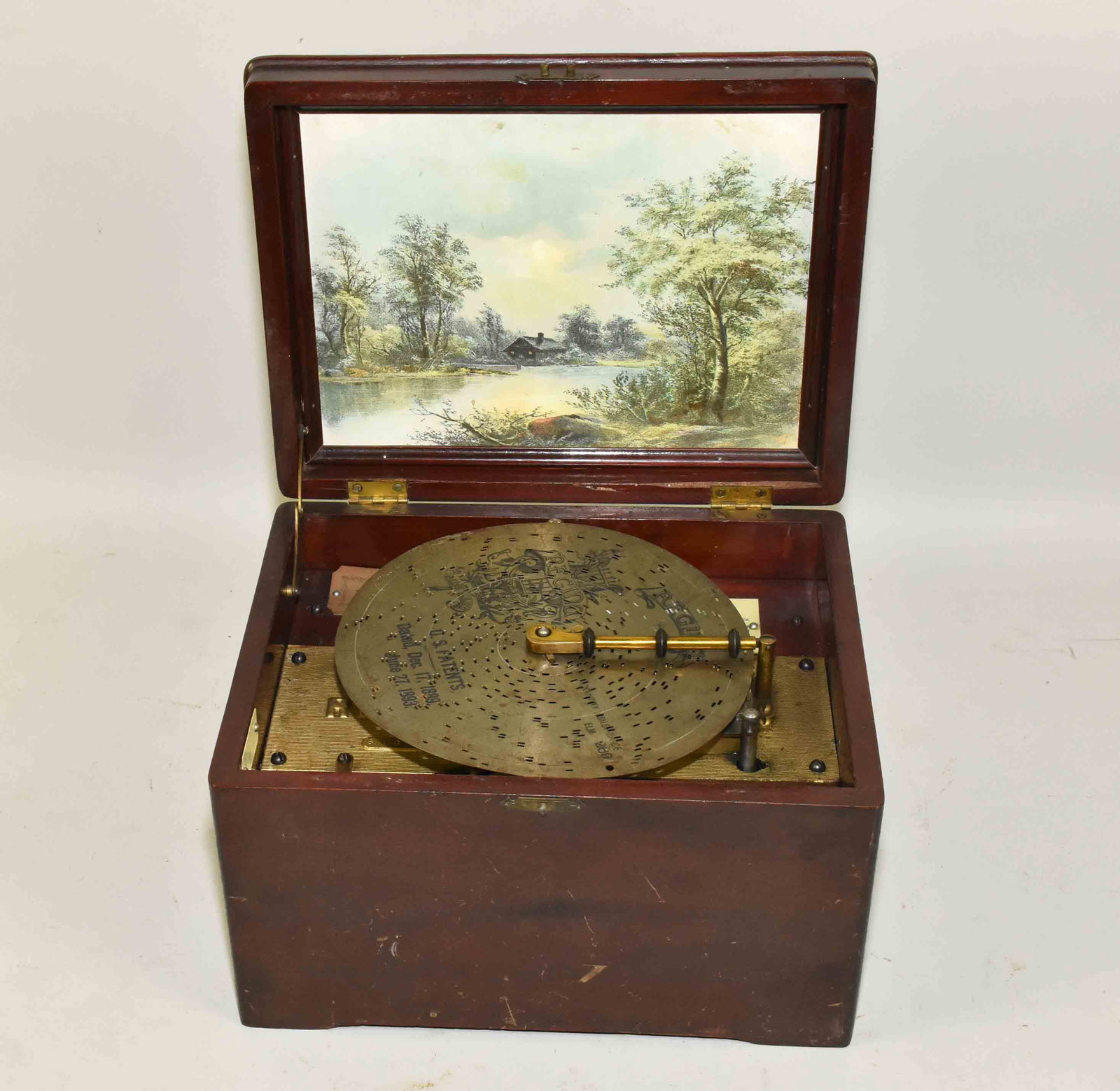 REGINA 8'' DISK PLAYER - #22. Also five 8'' perforated: REGINA 8'' DISK PLAYER - #22. Also five 8'' perforated steel discs, not tested. Appearance very good. Ca. 1890.