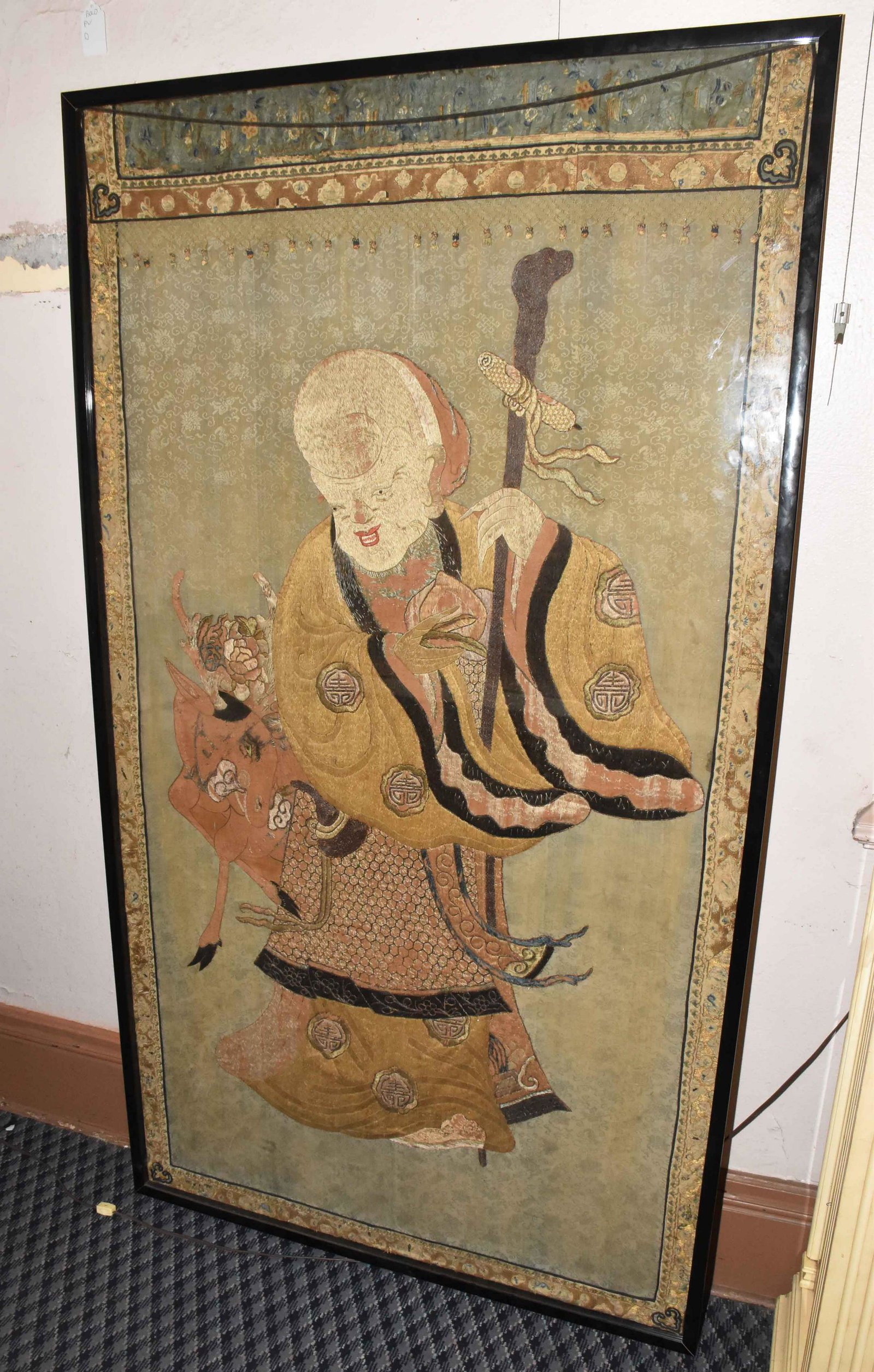 CHINESE EMBROIDERY OF THE GOD OF IMMORTALITY. Framed: CHINESE EMBROIDERY OF THE GOD OF IMMORTALITY. Framed and under plexiglass. 77.5 ''H x 43.5 ''W.