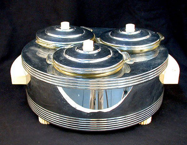 CHASE ELECTRIC SNACK SERVER. N/R. Polis: CHASE ELECTRIC SNACK SERVER. N/R. Polished chromium, plastic knobs. 1935. Electric snack server was designed by Howard Reichenbach for Chase, three one quart pyrex dishes were suspended in a chamber o