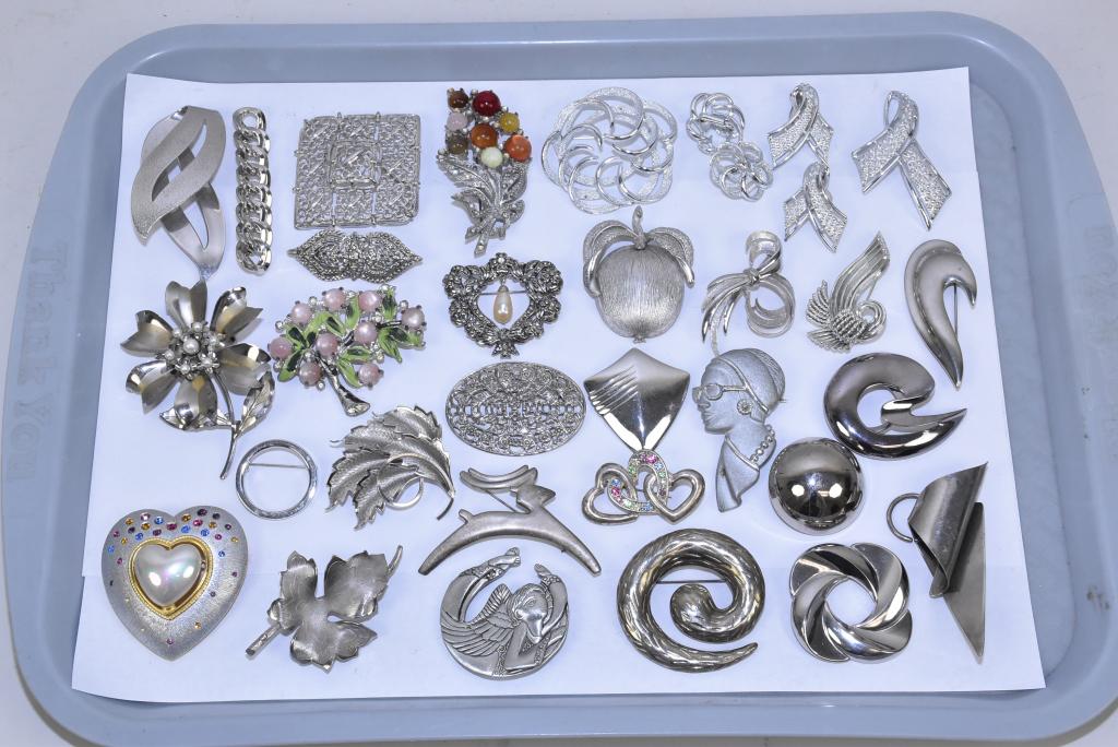 25 MISCELLANEOUS LADIES SILVER TONE BROOCHES: 25 MISCELLANEOUS LADIES SILVER TONE BROOCHES. Many assorted styles, with crystal, pearl and enamel bouquets, flowers and hearts. Signed pieces: Sarah C., Emmons, Craft, Trifari and Monet.