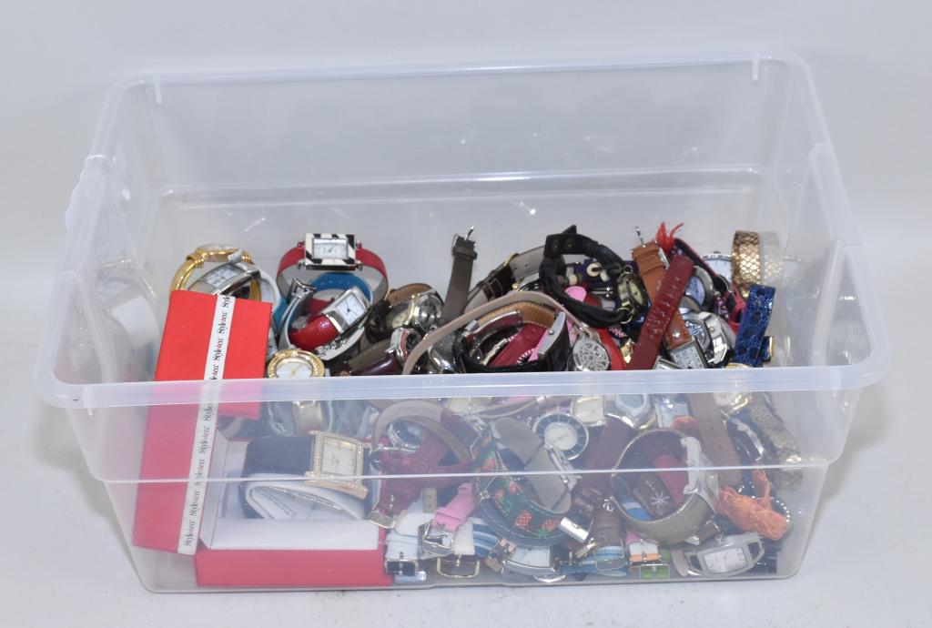 MEDIUM BIN OF MISCELLANEOUS WRISTWATCHES, WITH: MEDIUM BIN OF MISCELLANEOUS WRISTWATCHES, WITH LEATHER OR CANVAS BANDS. To include: Timex, Liz Claiborne, K. Cole, Geneva and many more signed pieces. Weight: 6 lbs. 5 oz.