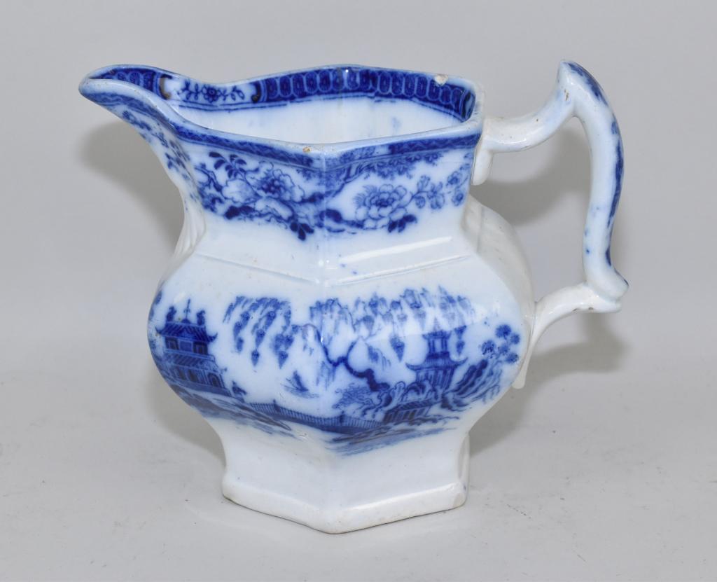 FLOW BLUE MILK PITCHER – HINDUSTAN pattern.: FLOW BLUE MILK PITCHER – HINDUSTAN pattern. (John Nardock, England 1855. 6” high. One small chip inside rim. Washable stains inside.