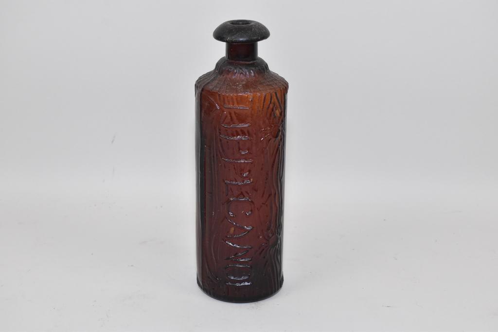 H.H. WARNER & CO., Tippecanoe Bitters Bottle: H.H. WARNER & CO., Tippecanoe Bitters Bottle – Rustic log form embossed body with a wide flaring lip. Bottom marked: Patent 83 Rochester, N.Y. Dark amber.