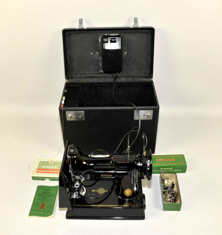 VINTAGE SINGER PORTABLE ELECTRIC SEWING MACHINE 22: VINTAGE SINGER PORTABLE ELECTRIC SEWING MACHINE 221 - 1, WITH CASE. Includes instruction book, 9 attachments, including darning and embroidery. Case: 10.5 ''H. X 14.25 ''W.