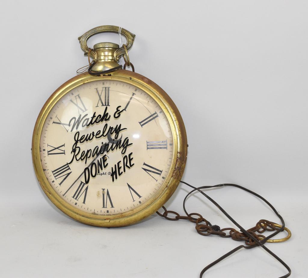 ADVERTISING POCKET WATCH FORM TRADE SIGN – Key: ADVERTISING POCKET WATCH FORM TRADE SIGN – Key wind, eight day clock with reverse painted logo on the convex glass, “WATCH AND JEWELRY REPAIR DONE HERE”. United Clock Corp. 13.5” diameter. Ele