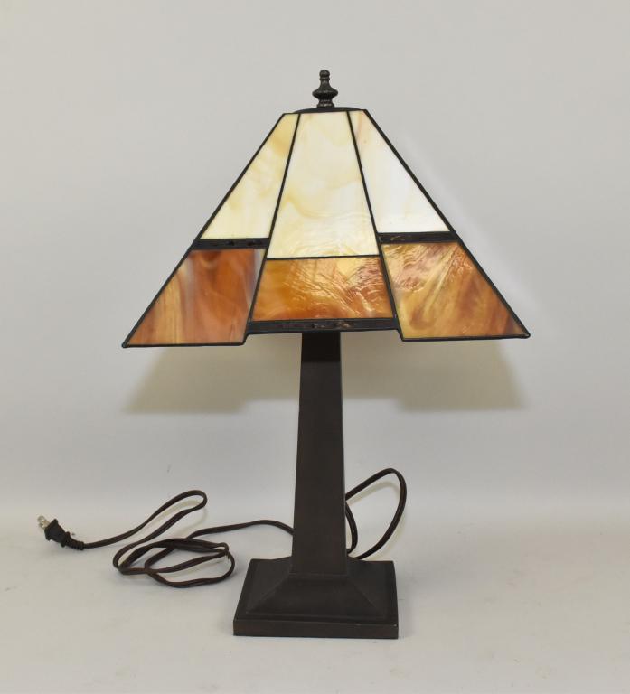 CARAMEL SLAG LEADED GLASS TABLE LAMP – Art Deco: CARAMEL SLAG LEADED GLASS TABLE LAMP – Art Deco design of square geometric configuration. Brown patinated metal base is11.5” high. The shade is worked in brown and light caramel slag glass and is 