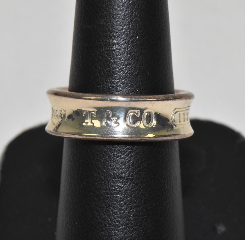 TIFFANY & CO. "1837" 925 STERLING SILVER RING: TIFFANY & CO. "1837" 925 STERLING SILVER RING. Size 7.25. Weight: 0.2 ozt. Band is 1/4"W., Mark: C 1997 T. & Co. 925.