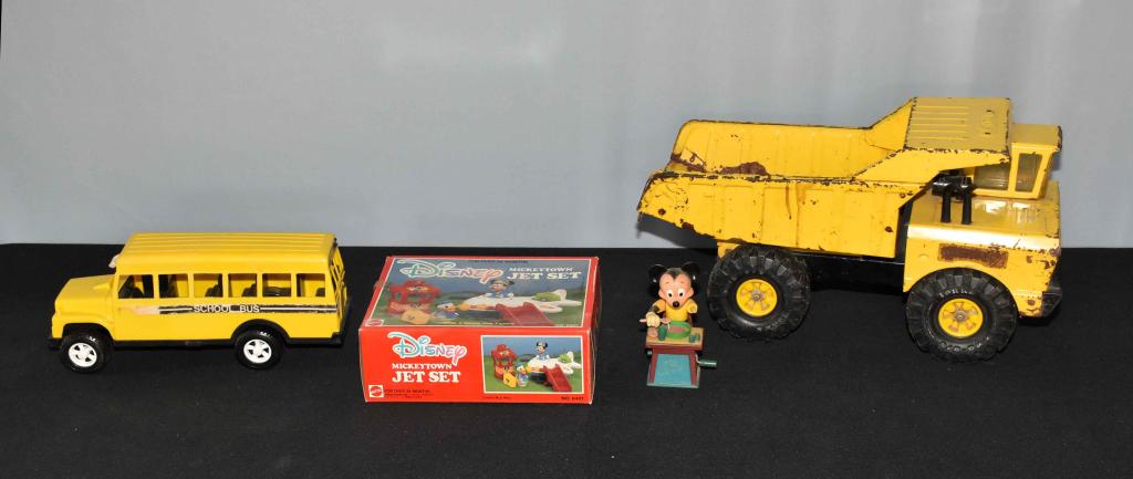 ASSORTED TOY LOT. School bus, Tonka truck, (2) Mic: ASSORTED TOY LOT. School bus, Tonka truck, (2) Mickey Mouse toys. Condition: arm missing from Mickey Mouse toy.