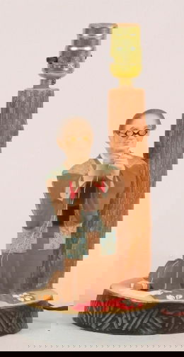 HAKATA URASAKI DOLL LAMP: HAKATA URASAKI DOLL LAMP. Hakata Urasaki doll lamp, 20th c. ceramic figure of old woman threading bobbin lamp with original box. Marked: paper label: Urasaki Doll Fukuoka Japan. Size: 13''H, 6''diam.