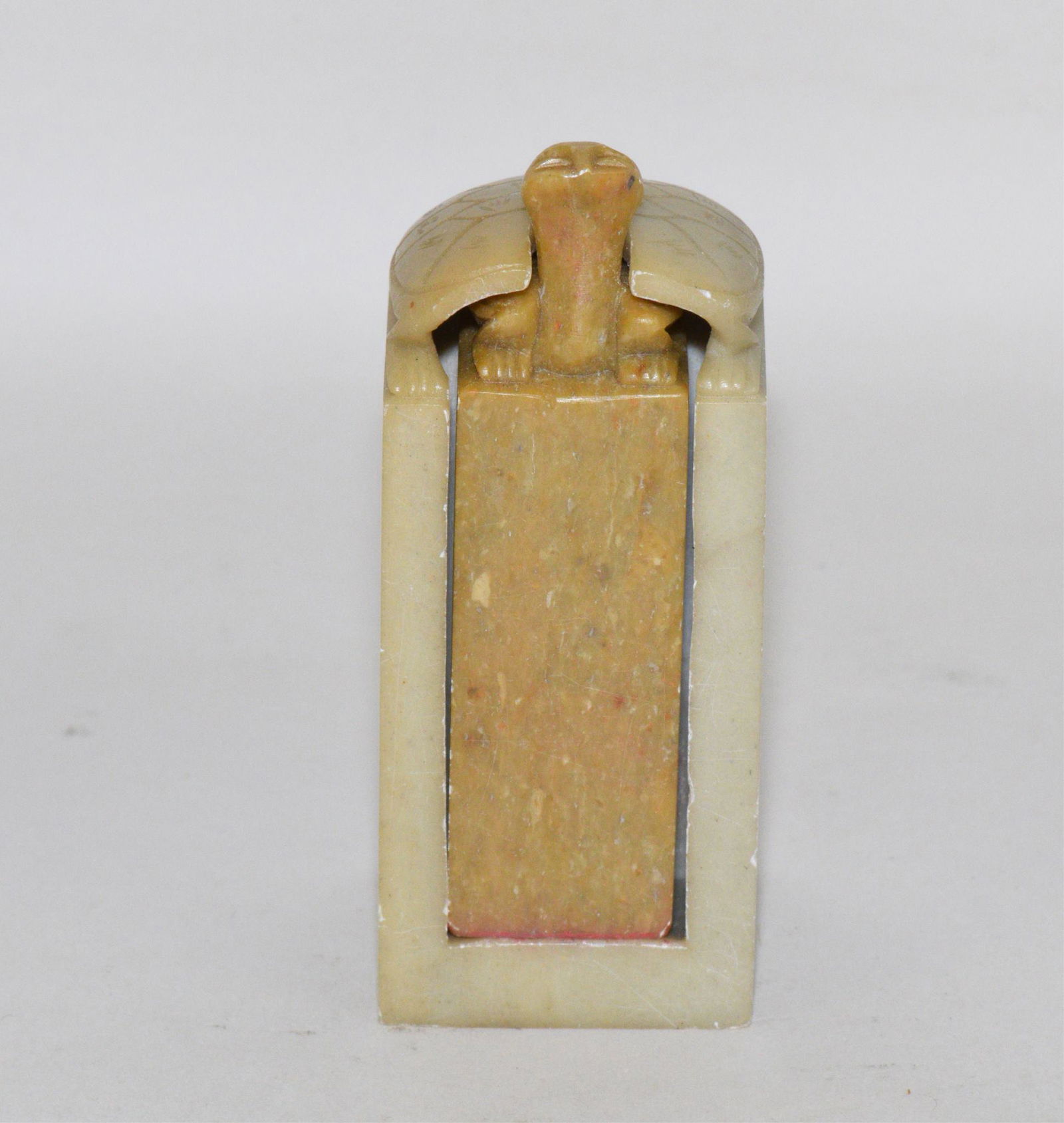 CHINESE SOAPSTONE CASED SEAL - The seal in tan: CHINESE SOAPSTONE CASED SEAL - The seal in tan stone with the figure of a turtle head and paws and contained in a light grey "cabinet" with the shell of the turtle on top. Uncarved with signature.
