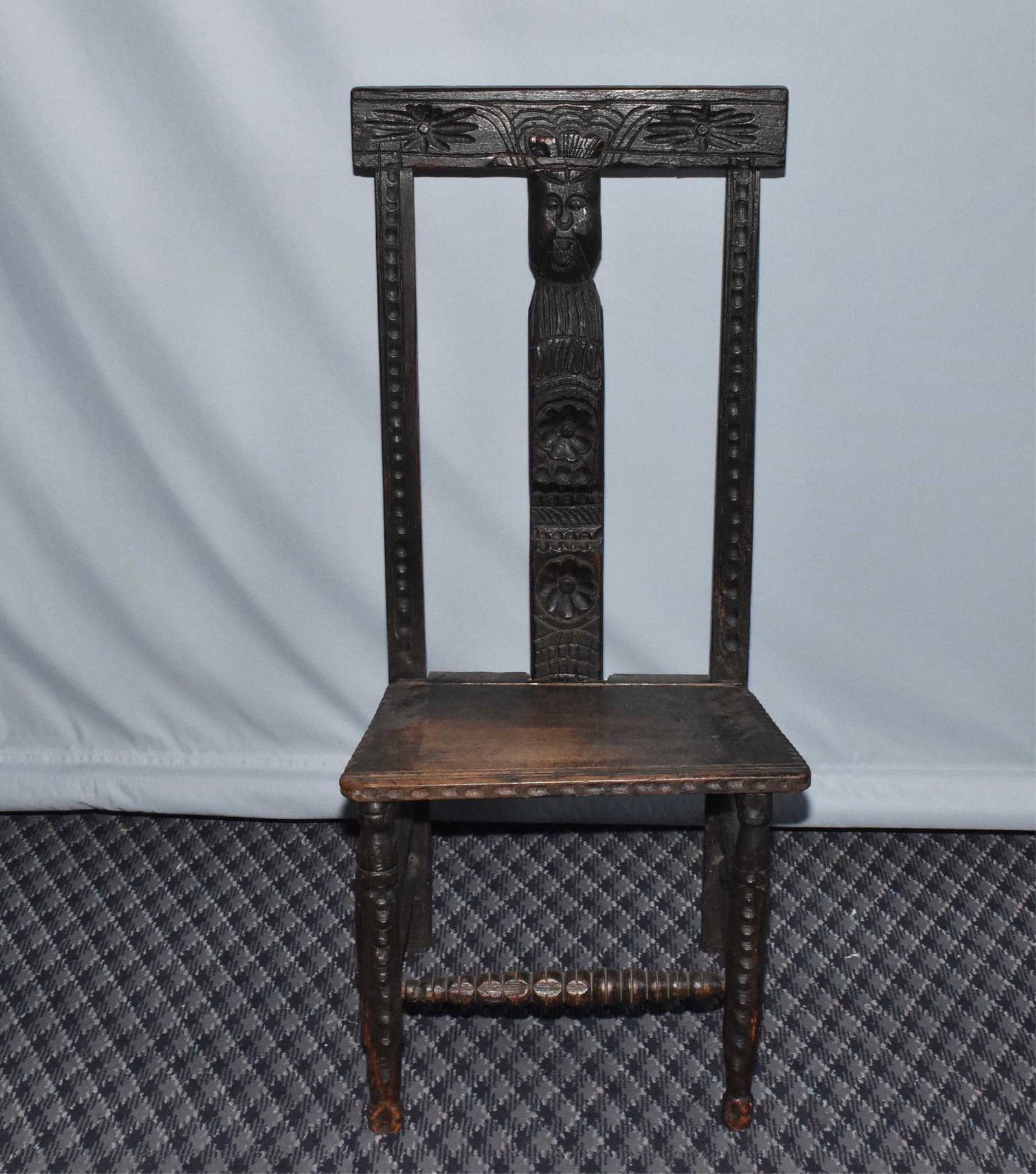 SCOTTISH CARVED PROVINCIAL FIRESIDE CHAIR: SCOTTISH CARVED PROVINCIAL FIRESIDE CHAIR - 18th century. Wear, restoration and age related degradation. 39.5" back height, width 18.5", front leg height 15.75", rear seat height 13.5".