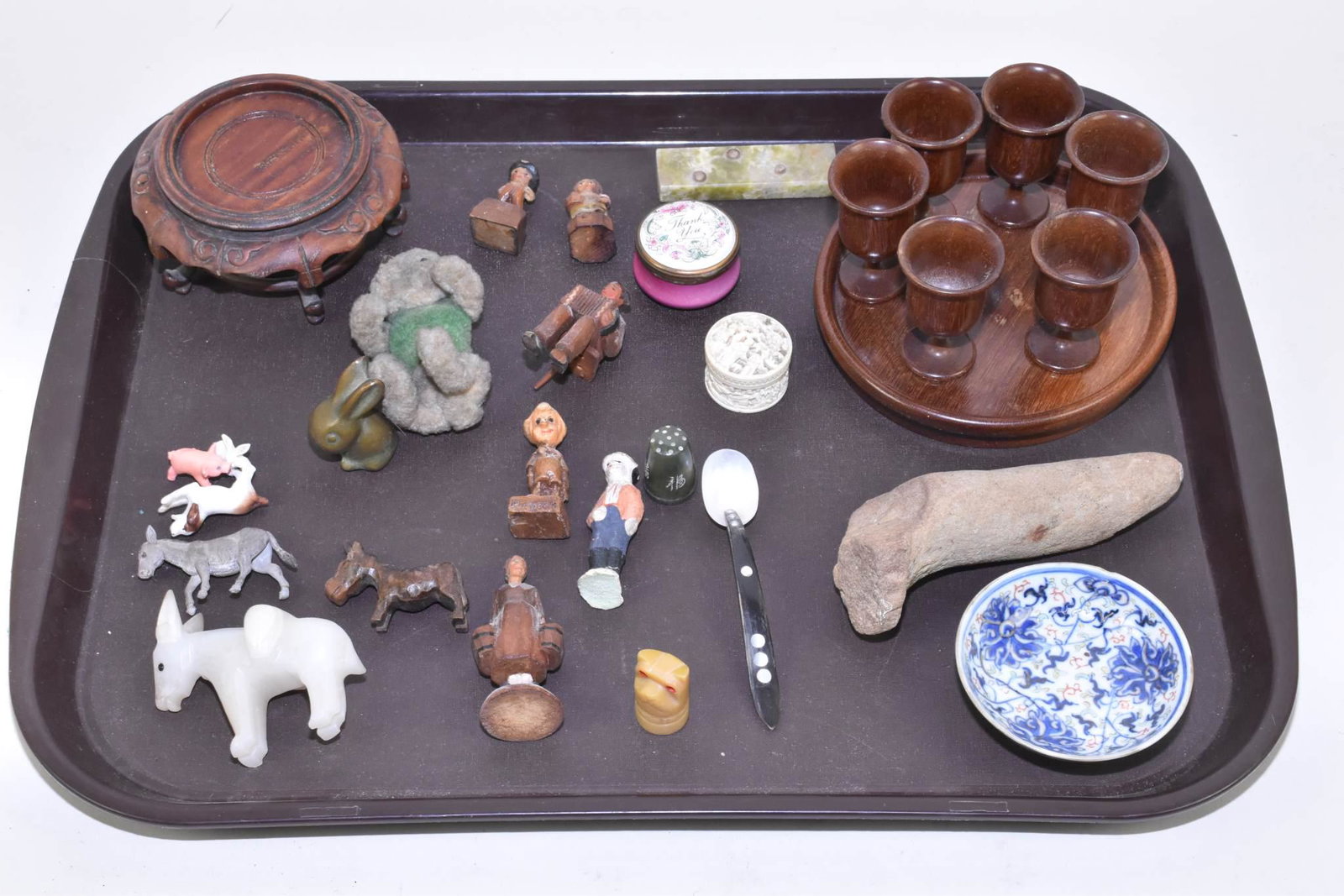 ASSORTED WARES - 28 assorted miscellaneous items: ASSORTED WARES - 28 assorted miscellaneous items. Including: 14 wood carvings; 6 small animals including a brass bunny, alabaster donkey, miniature teddy bear, stalagmite, bone and shell caviare spoon