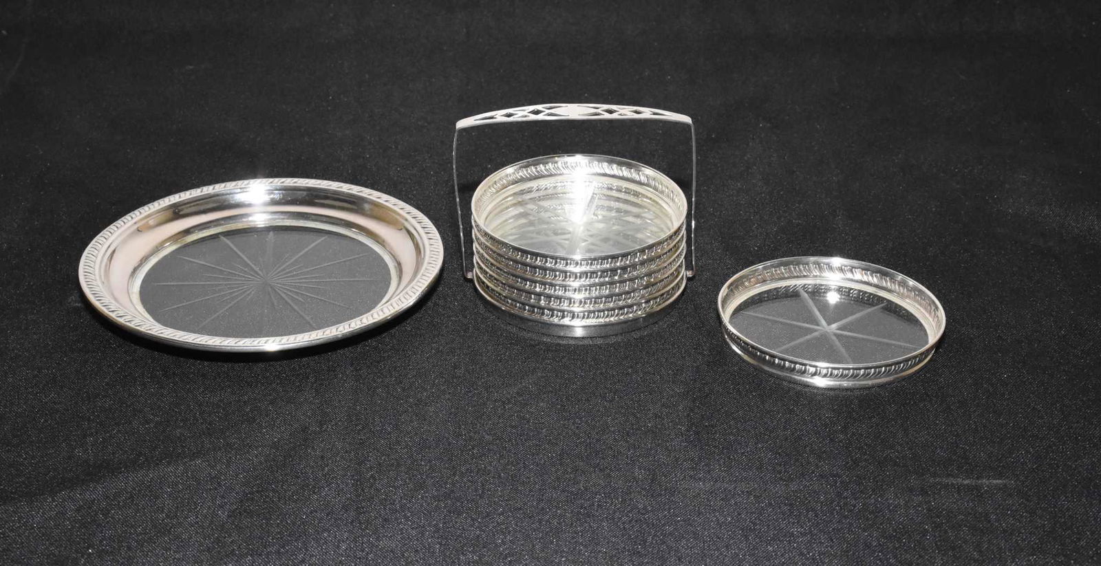 STERLING RIM COASTERS - In caddy. Plus a large: STERLING RIM COASTERS - In caddy. Plus a large sterling rim wine bottle coaster.