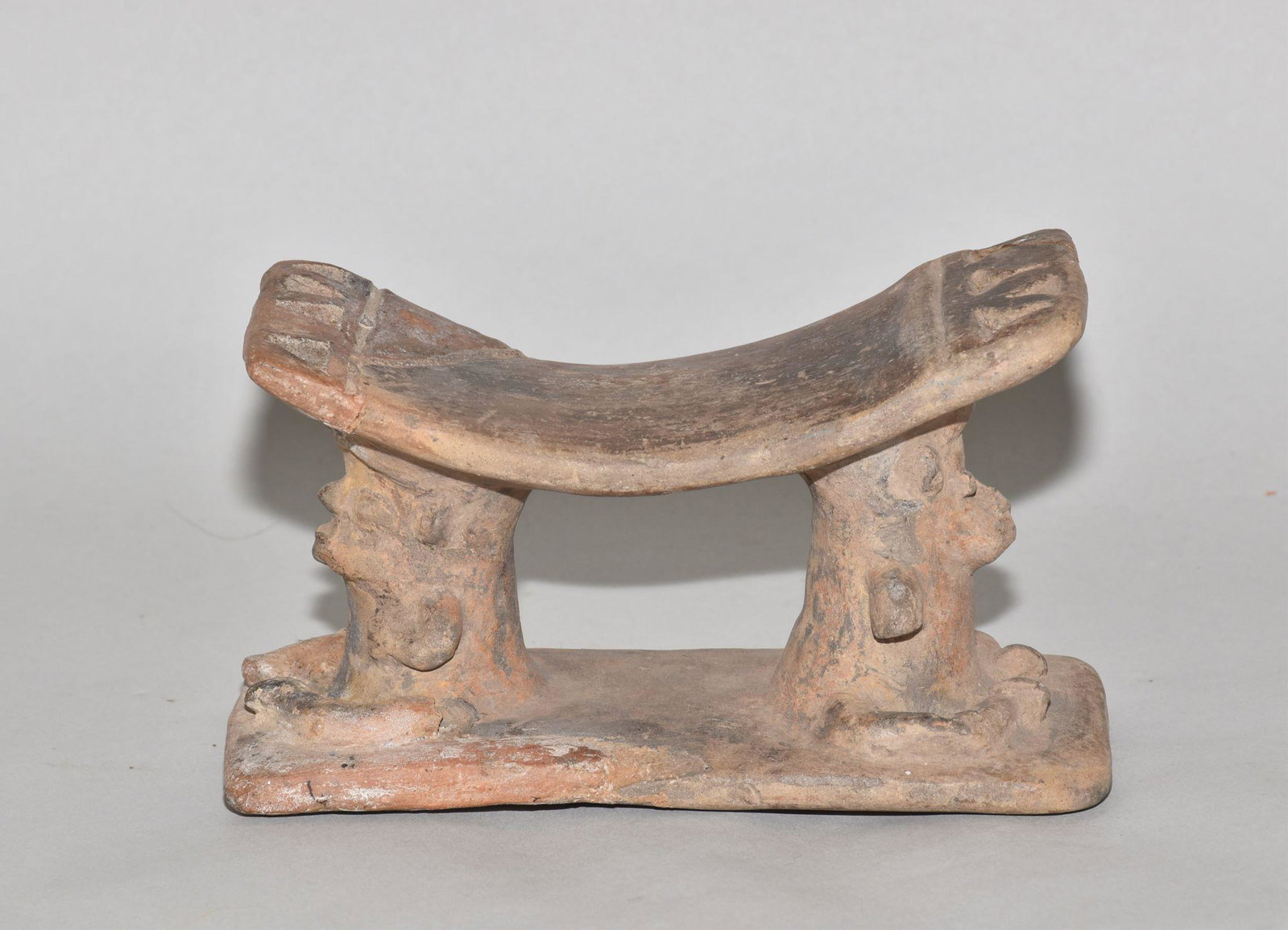 PRE-COLUMBIAN POTTERY PILLOW: PRE-COLUMBIAN POTTERY PILLOW. Approximately 6" long by 3" high. Condition: very good with age appropriate wear.
