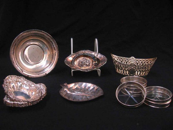 SILVER SERVEWARE N/R.: SILVER SERVEWARE N/R. Lot includes one round sterling dish; one sterling leaf design dish; four sterling dishes embossed with a floral design; one garland and bow embossed open weave boat-shaped bowl;
