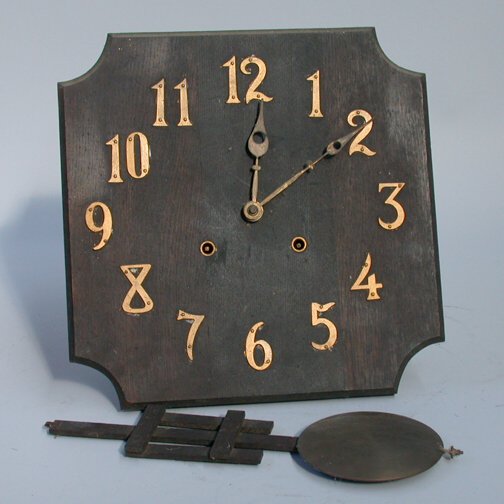 MISSION STYLE WALL CLOCK: MISSION STYLE WALL CLOCK. N/R. Wooden mission style wall clock ith exposed wood and brass pendulum, arts and crafts style metal numbers, no mark. Key wind half hour and hour strike. Size: 24"H. 13"W,
