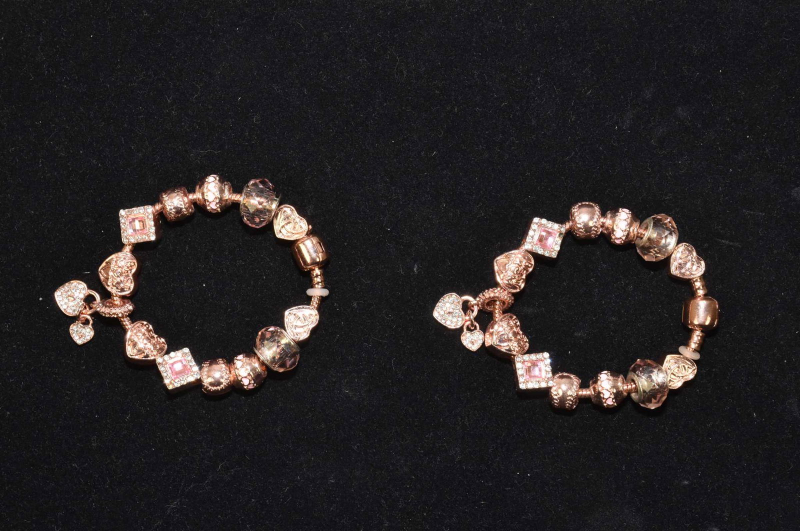 TWO 925 ROSE VERMEIL SNAKE CHAIN BRACELETS: TWO 925 ROSE VERMEIL SNAKE CHAIN BRACELETS WITH 26 ROSE TONE CHARMS, 0.6 TROY OUNCES. Each bracelet with 13 assorted charms.Length 6.5 inches, weight each 0.3 Troy ounces.