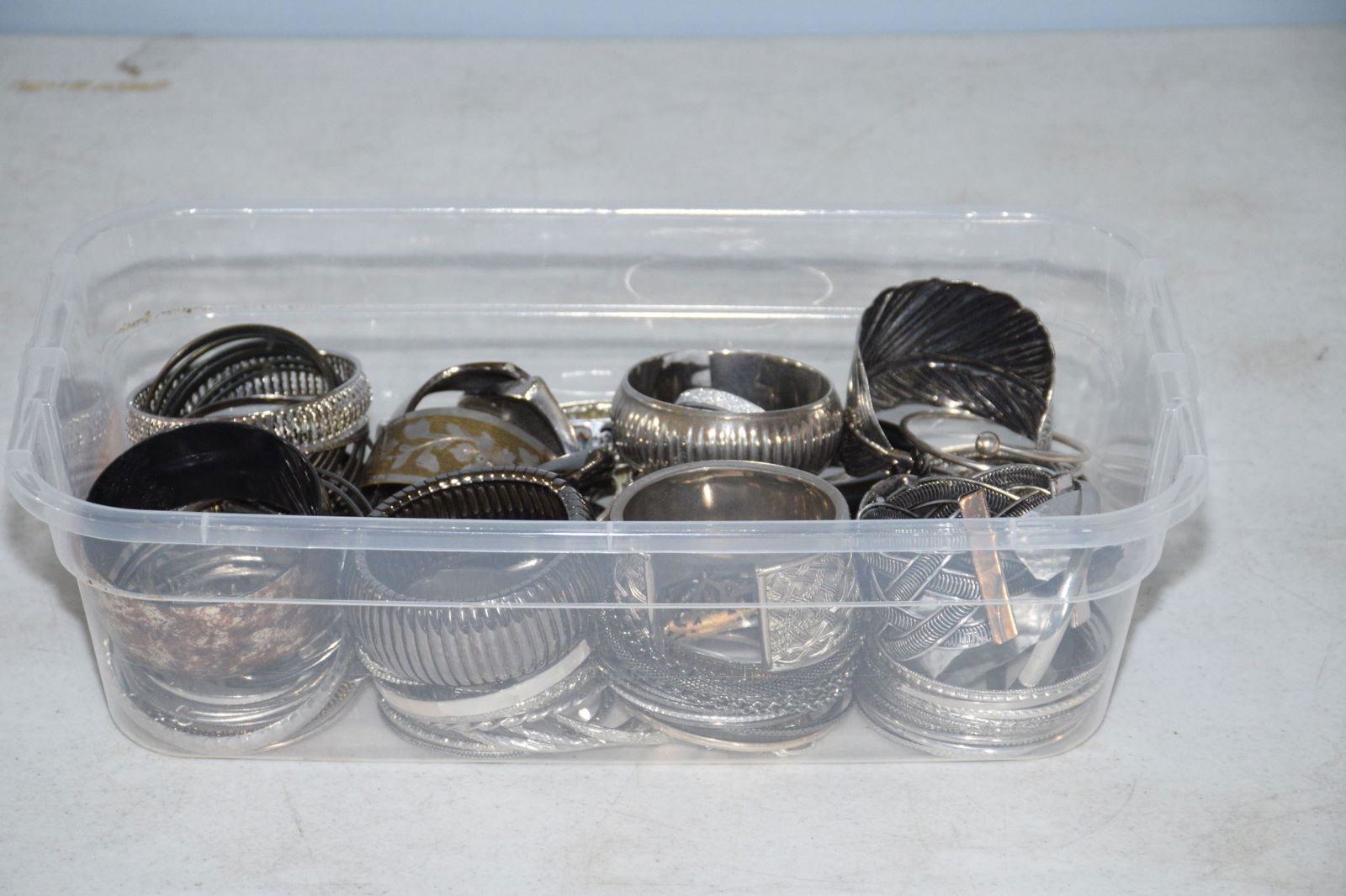 BIN OF ASSORTED SILVER TONE BRACELETS AND BANGLES (1 of 2)