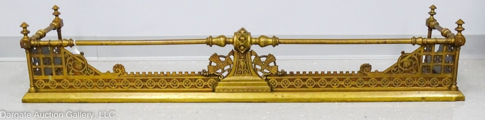 1882 AESTHETIC MOVEMENT BRASS FIREPLACE FENDER: 1882 Aesthetic Movement Brass Fireplace Fender PAT Sept 19, 1882 / Measures: 10"H x 54"L x 14"D / Condition: Back corners on bottom somewhat bent, dent in brass lower front right corner