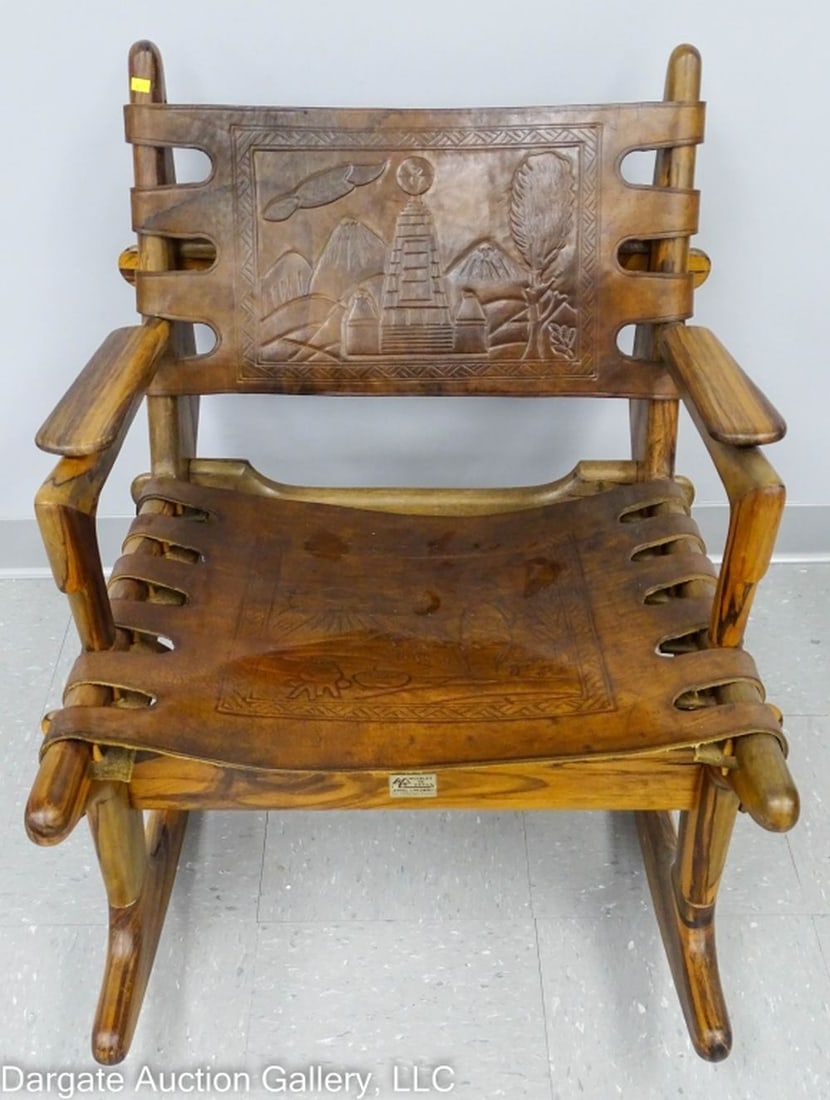 MCM ECUADORIAN ANGEL PAZMINO LEATHER SLING ROCKER: Circa 1960 / Mid Century Modern Leather Sling Rocker Designed by Angel I Pazmino for Muebles de Estilo / Tropical hardwood, pinned construction, tooled leather with vulcano and farm scenes / Measures: