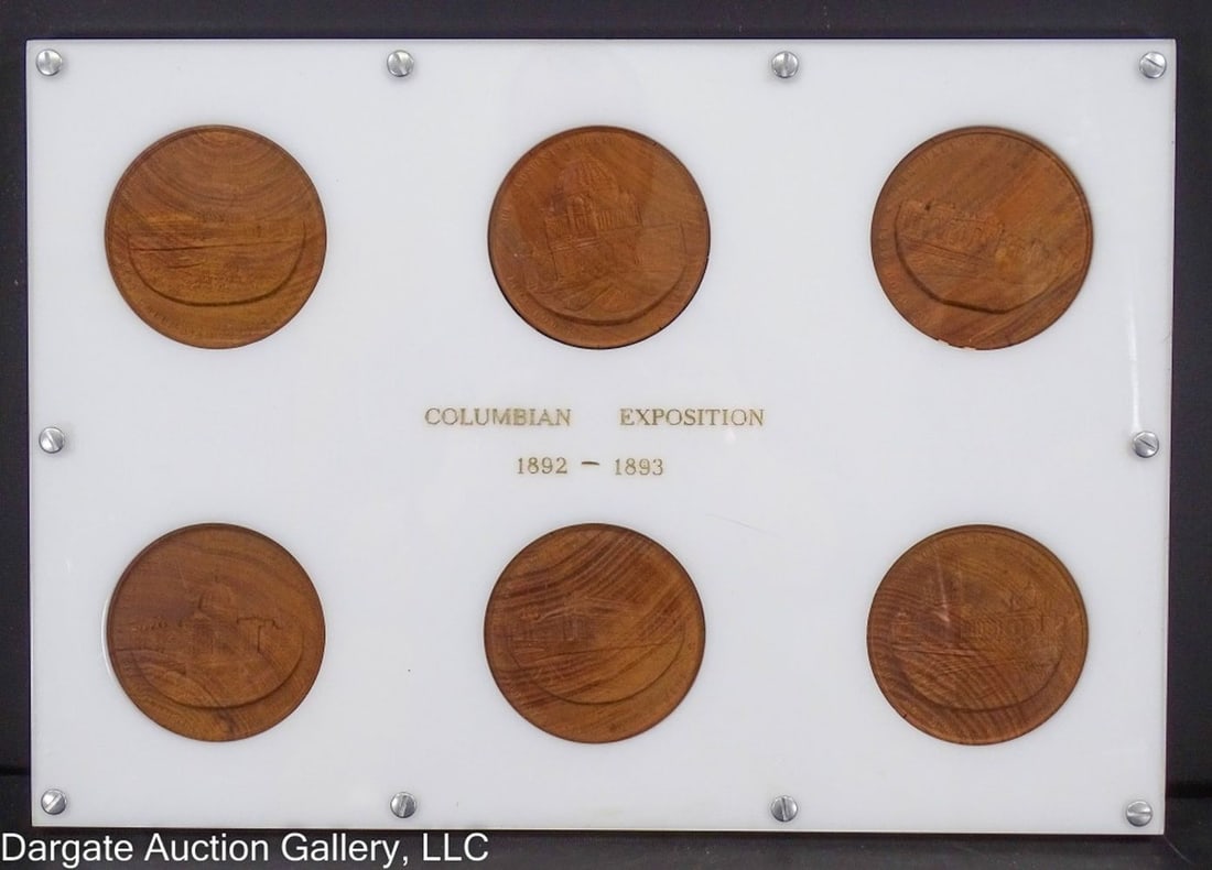 SET OF 6 COLUMBIAN EXPOSITION WOODEN MEDALS: The 6 wooden medals are set in plexiglass with a paper sticker visible on the back (Set inside with the medals) from T.W. & C.B. Sheriden Paper Cutters and Bookbinders Machinery. / The medals in the s
