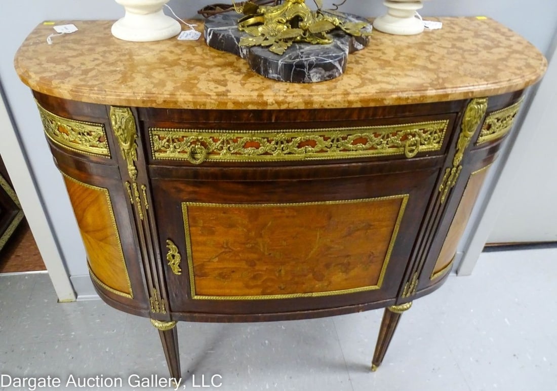 LOUIS XV DEMILUNE MARBLE TOP CABINET: Louis XV Demilune Marble Top Cabinet - Circa 20th Century / Nice Louis XV demilune satinwood and mahogany cabinet, salmon colored marble top, bronze attachments, floral mahogany door / Measures: 32.5"