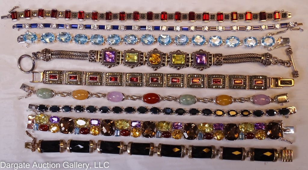 9 STERLING SILVER AND GEMSTONE LINK BRACELETS: Includes: (1) NF Sterling set with red stones (7.5?L) / (1) Sterling and Onyx (7.5?L) / (1) Sterling and red stone (8.5?L) / (1) Multi-color gemstone Sterling (7.5?L) / (1) Sterling and light blue top