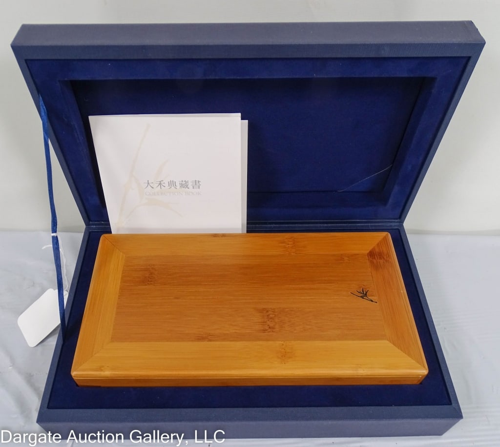 DAHE BAMBOO TURNLOCK BUTTONED BOX BY BAMBOOLA: Lion-head turn lock with sliding lid. Inside is lined with a removeable inner lid. Bamboo image on lid. In original fitted box / Box: 2.25"H x 5.25"W x 10.25"L / Fitted box 3"H x 12"L x 7.25"D / Condi