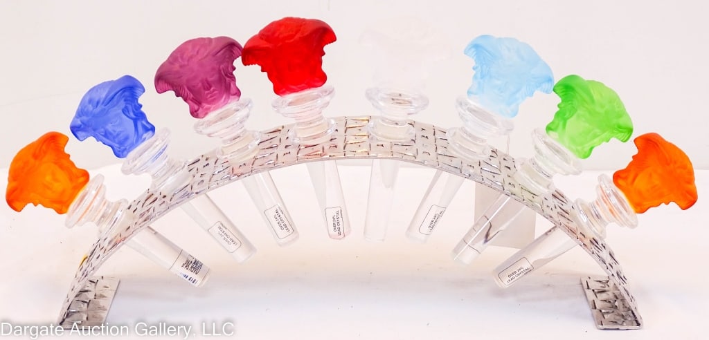 SET OF 8 VERSACE MEDUSA BOTTLE STOPPERS: Medusa head bottle stoppers made by Rosenthal Porcelain, in holder / acid etched Versace and Rosenthal marks, some have stickers / Measures: 7"H x 15"W x 2.5"D / Provenance: From the descendants of Lo