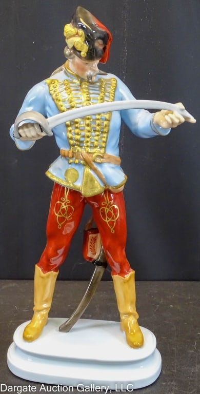 HEREND PORCELAIN FIGURE OF HADIK HUSSAR: Circa 20th Century / Herend mark on base / Depicts Hungarian Hero Hadik Hussar examining his sword / Measures: 12.5"H x 5.5"W