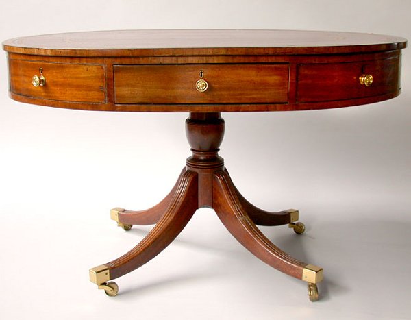 GEORGE III OVAL LIBRARY TABLE. N/R. Eng: GEORGE III OVAL LIBRARY TABLE. N/R. English, mixed woods of oak, pine, and mahogany. Oval library table with inset red leather top, the frieze fitted with four real drawers and four false drawers on a