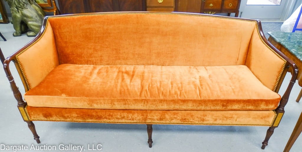 MODERN MAHOGANY SHERATON SOFA: Reeded columns and legs, burled maple inlay, head to head brass tack, crushed velvet upholstery, loose one piece cushion with the down clips / Measures: 35"H (middle of the back) x 74"W x 28"D / Prove