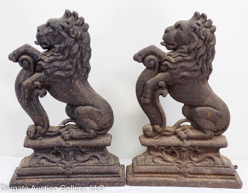 PAIR CAST IRON RAMPANT LION ENGLISH DOORSTOPS: A pair of English rampant lion doorstops. Older black painted finish. Wear and chipping to paint, one lion shows better details. / Measures: 15" x 2.75" x 10" / Provenance: From the descendants of Lol