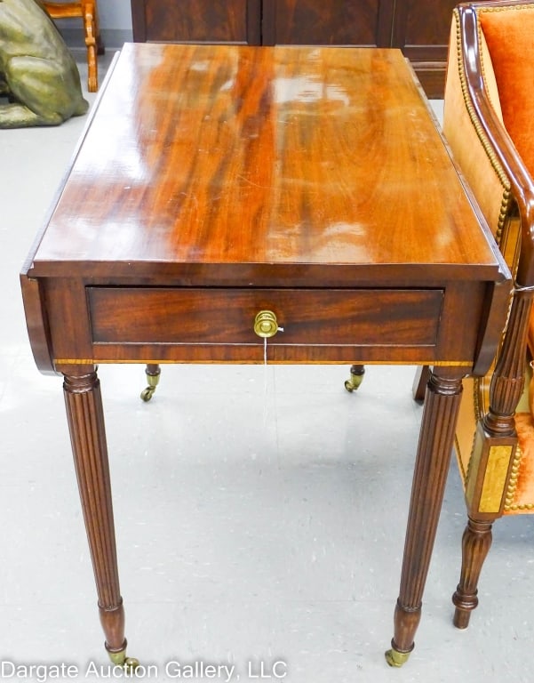 AMERICAN SHERATON PERIOD MAHOGANY DROPLEAF TABLE: A period American Sheraton mahogany drop leaf table with modified "D" shaped drop leaves. Reeded legs with brass castors. One faux drawer, one real drawer, with cockbeading detail and brass knobs, ban