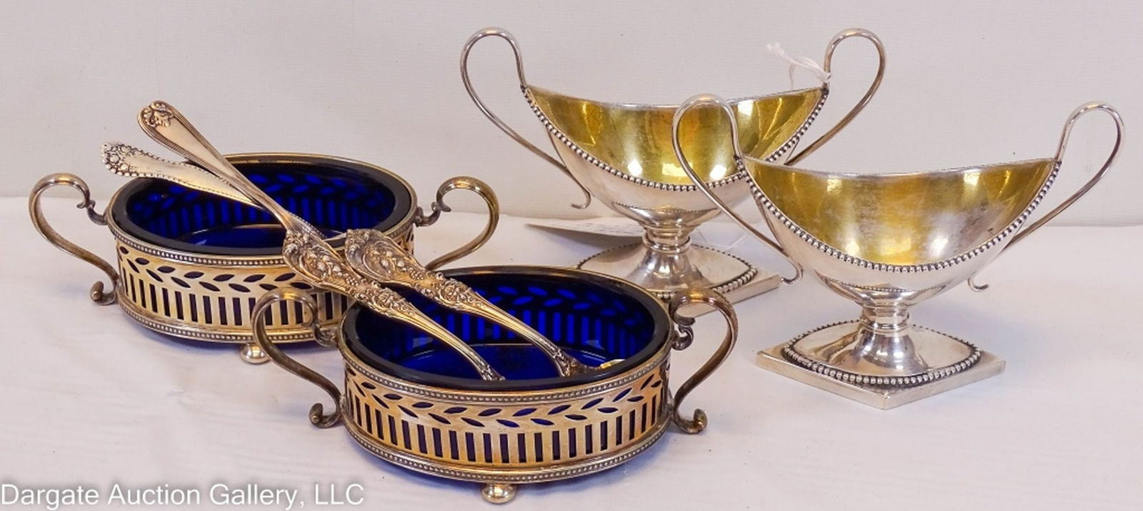 4pc TIFFANY & CO STERLING SALTS & Asst SPOONS: Includes: (1) Pair Sterling salt cellars with cobalt liners (1.75"H x 4.75"W x 2.5"D) / (1) Pair Salt cellars with gold washed interior / (4) Sterling Salt spoons (1 - Tiffany & Co, 1 - Lancaster Rose